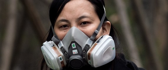 A woman wearing a protective pollution mask walks on a street in Beijing on March 20, 2017.
The last large coal-fired power plant in Beijing has suspended operations, with the city's electricity now generated by natural gas, the state news agency reported as smog enveloped the Chinese capital this past weekend. / AFP PHOTO / NICOLAS ASFOURI        (Photo credit should read NICOLAS ASFOURI/AFP/Getty Images)