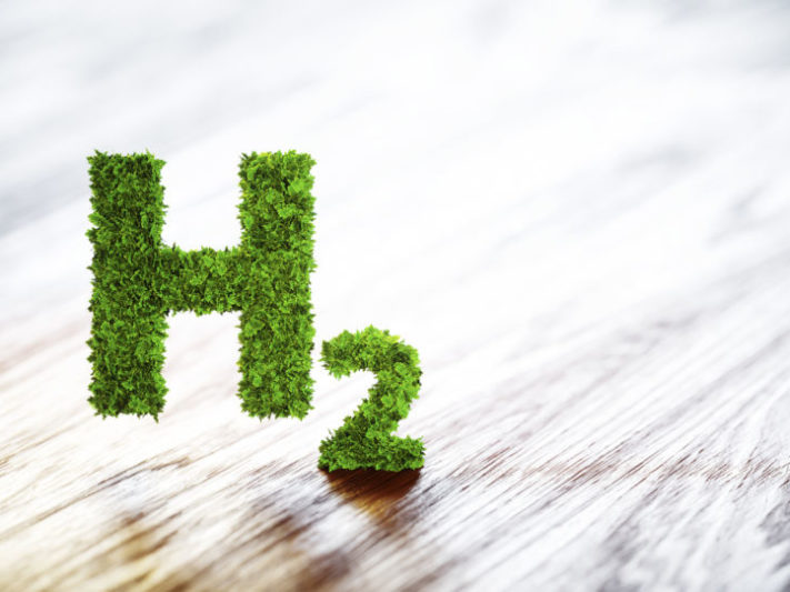 Green hydrogen element sign on blurred wooden background. 3D illustration.