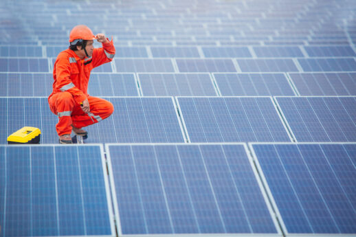 The male employee maintenance panels collect solar energy. Engineer working on checking and maintenance equipment at industry solar power.