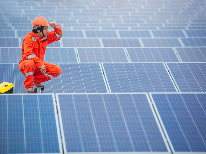 The male employee maintenance panels collect solar energy. Engineer working on checking and maintenance equipment at industry solar power.